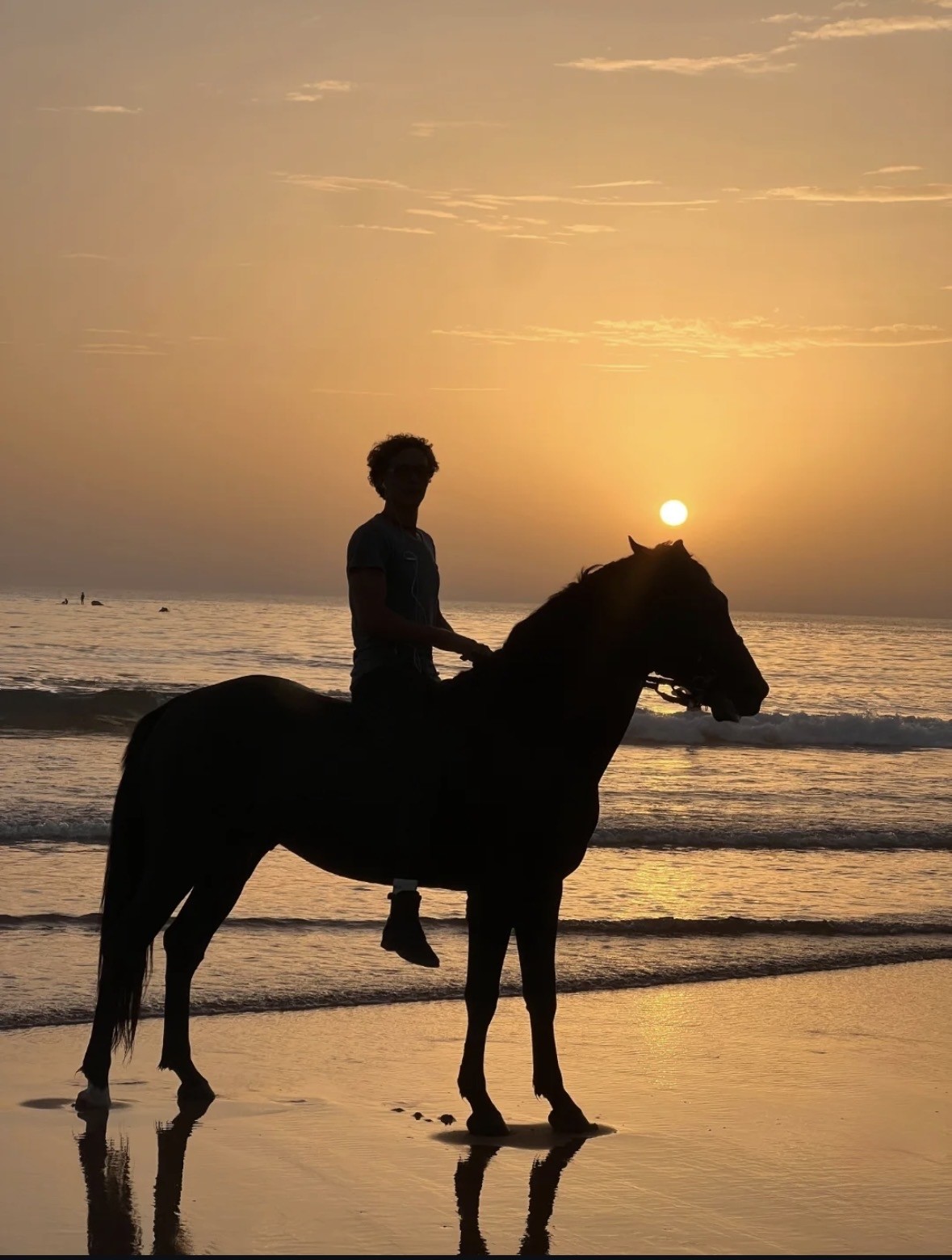 Horse galloping along the beach at sunset in Essaouira